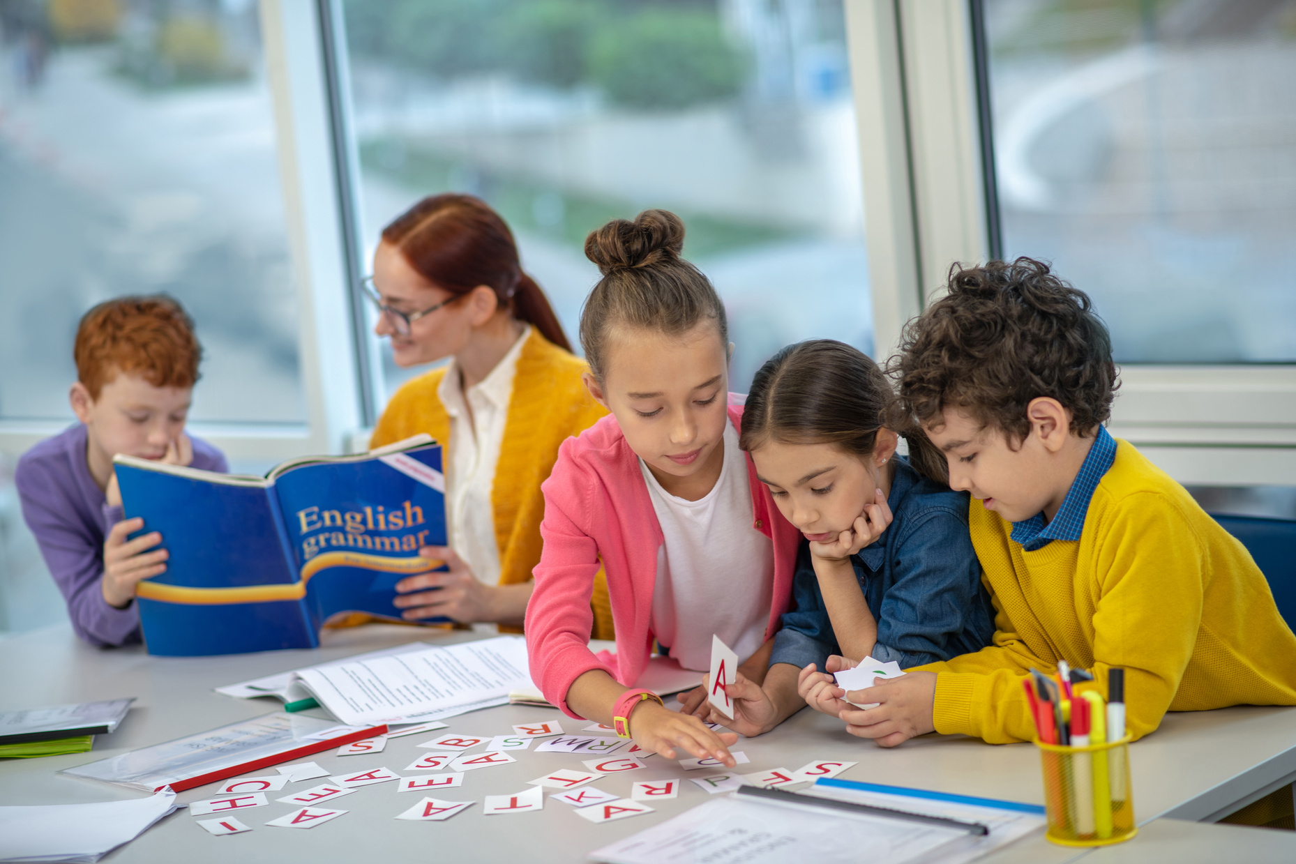 Concentrated children learning English grammar at school